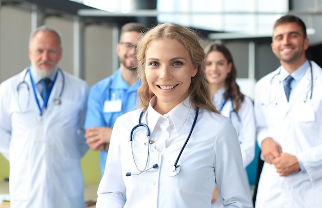 Female doctor with group of happy successful colleagues.