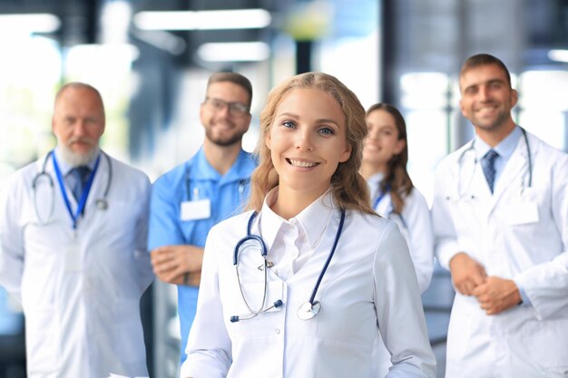 Female doctor with group of happy successful colleagues