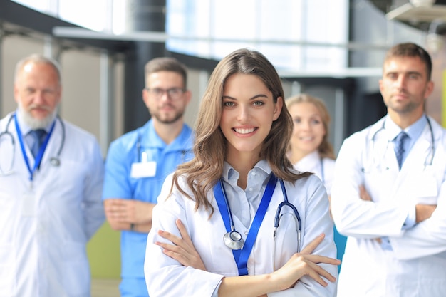 Female doctor with group of happy successful colleagues.