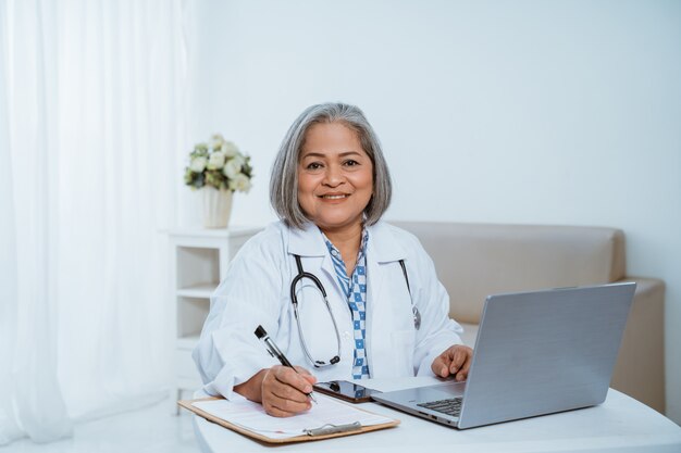 Female doctor with a laptop on the table