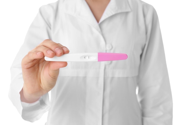 Photo female doctor with pregnancy test on white background closeup