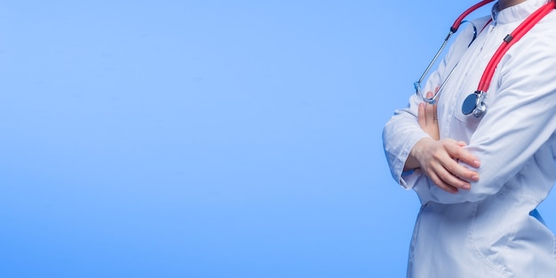 female doctor with stethoscope in blue background.