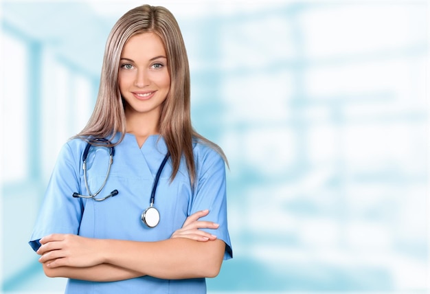 Female doctor with stethoscope in a blue coat  on blurred background