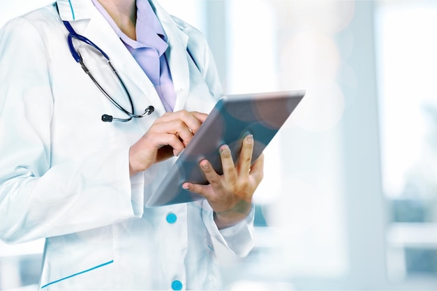 Female doctor with stethoscope and digital tablet