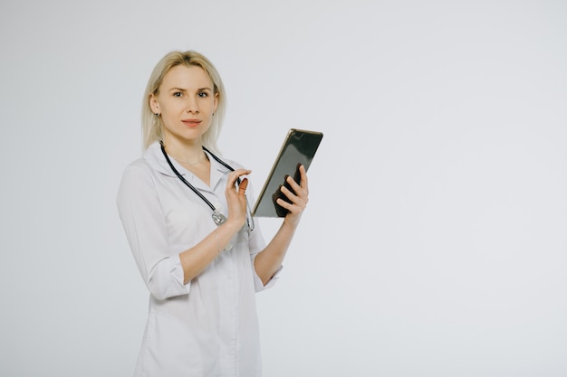 Female doctor with tablet pc writing prescription. Medicine, health and hospital concept.