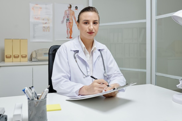 Female doctor working at her office