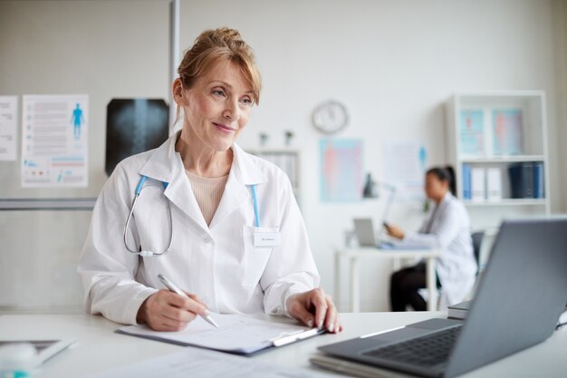 Female doctor working on laptop