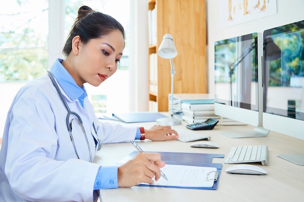 Female Doctor Working In Office