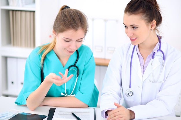 Female doctor  and young surgeon intern in hospital