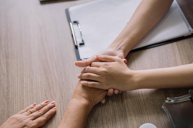 Female doctors shake hands with patients encouraging each other To offer love concern and encouragement while checking the patient's health concept of medicine