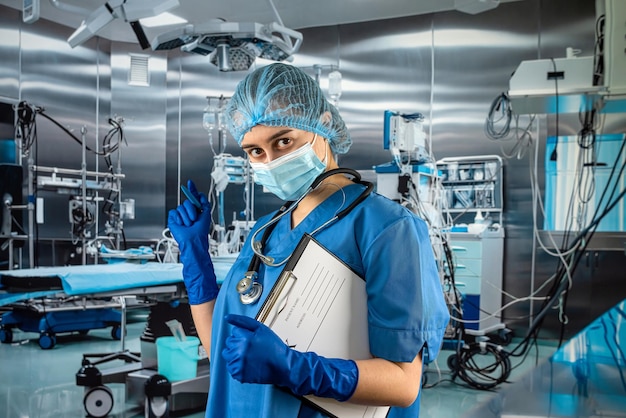 Female doctors in uniform standing at operation room are recorded patient data for analysis rx Medical concept