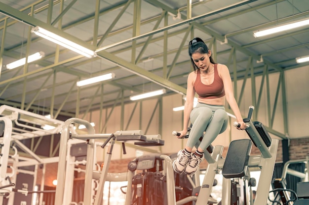 Женщина делает упражнения с силовыми тренировками в фитнес-зале