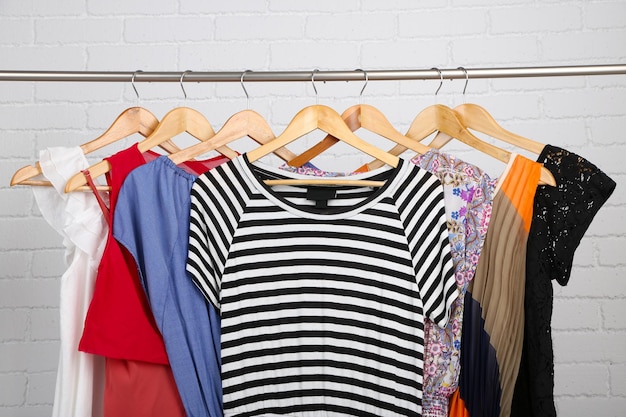 Female dresses on hangers in room