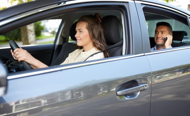 female driver driving car with male passenger