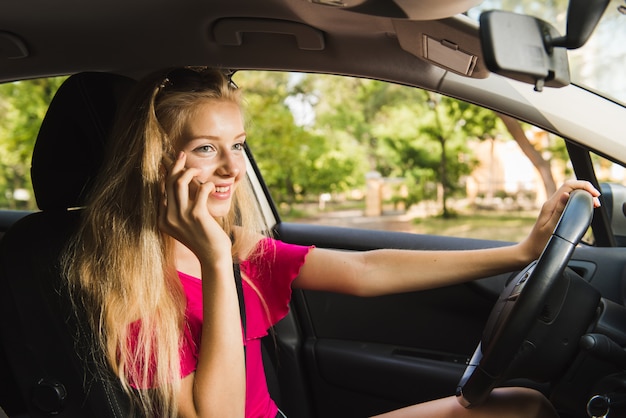 Female driver talks by mobile phone