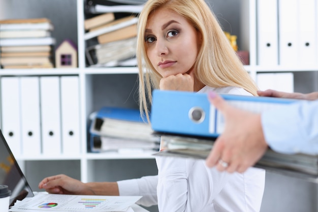 Female employee show pack of documents