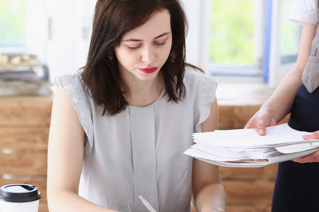 Female employee showing pack of documents