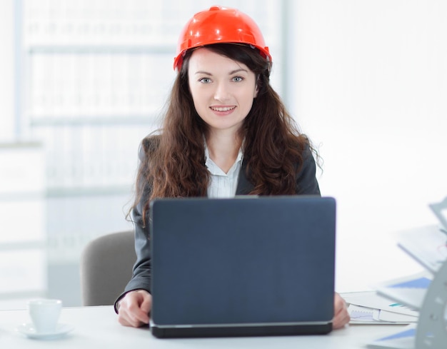 Female engineer sitting in front of an open laptop