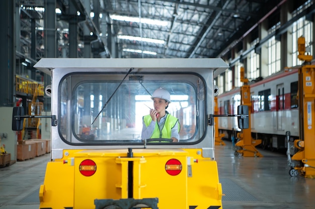 Female engineer working in electric train repair shop Test driving a small grinding the railroad