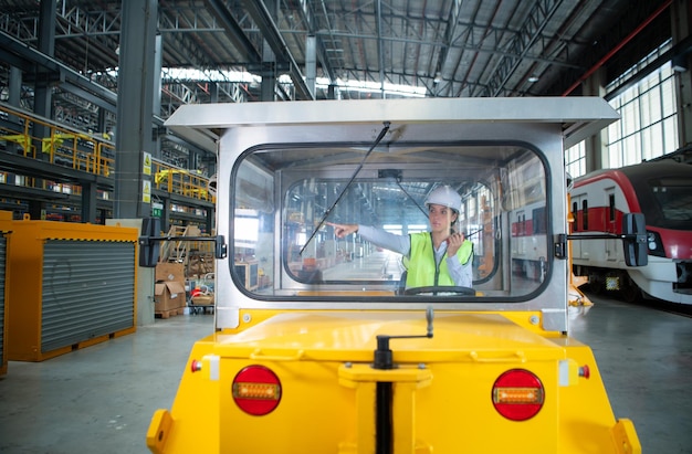 Female engineer working in electric train repair shop Test driving a small grinding the railroad