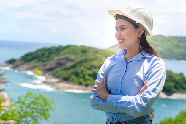 Female engineer working on the seaside wearing a protective helmet x9