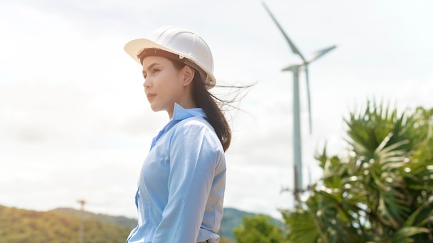 Female engineer working on the seaside wearing a protective helmet