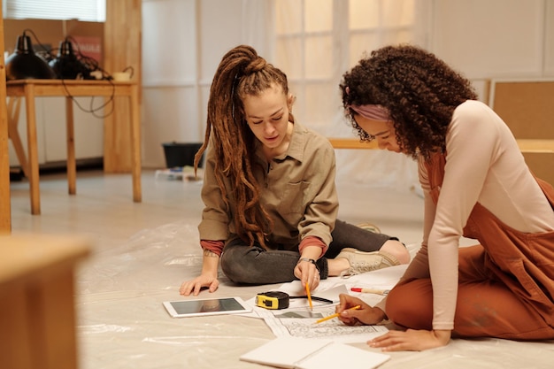 Female entrepreneur pointing at sketch