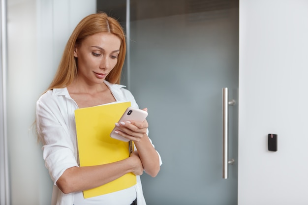 Female entrepreneur using her smartphone