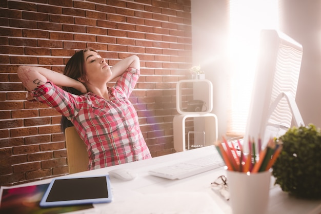 Female executive relaxing at her desk