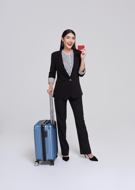 Photo female executive with suitcase in work related business trip showing credit card