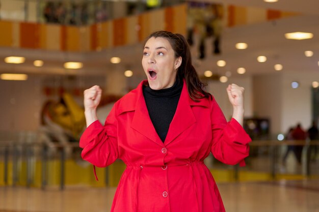 Photo female in extreme jubilation raises fists in pure celebration