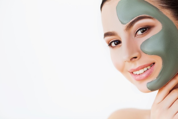 Female face with perfect skin and gray spa mask