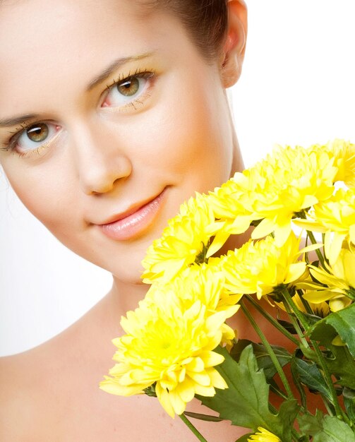 Female face with the yellow chrysanthemum