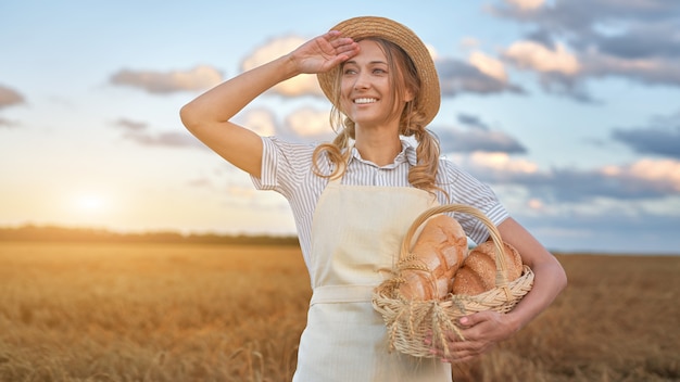 Female farmer holding a basket with bread