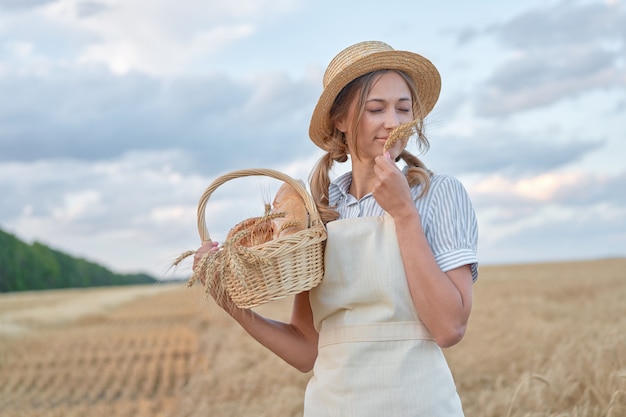 Female farmer holding a basket with bread