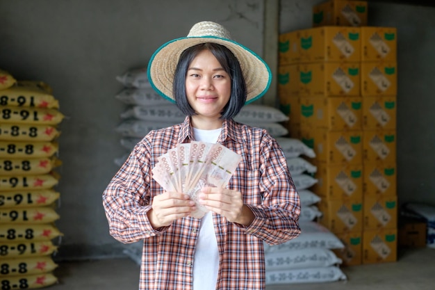 Female farmers pose with banknotes to promote their products