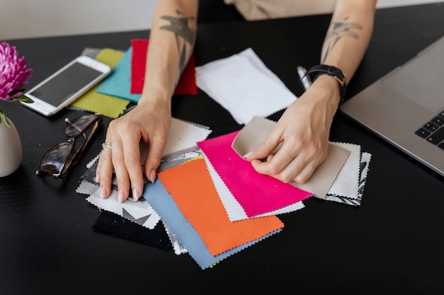 Female fashion designer choosing fabric samples