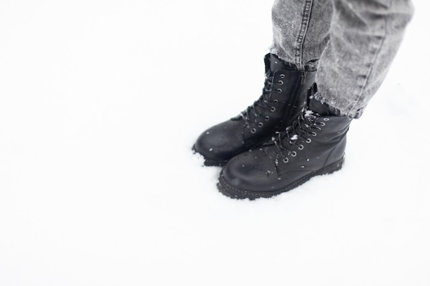 Female feet in boots in the snow