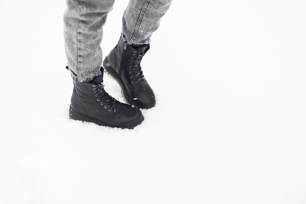 Female feet in boots in the snow