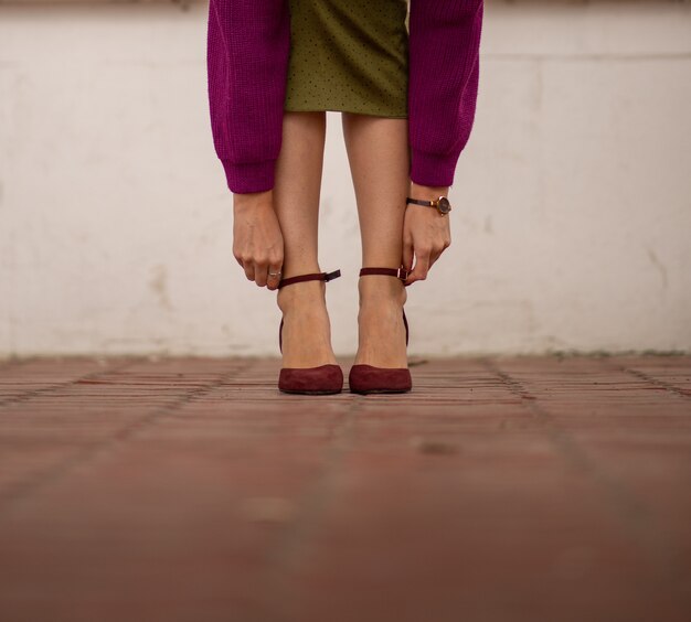 Female feet in shoes on the sidewalk