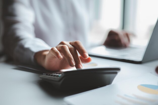 A female financier is reviewing company financial documents monthly financial statement summary from the finance department The concept of managing the company's finances for accuracy and growth