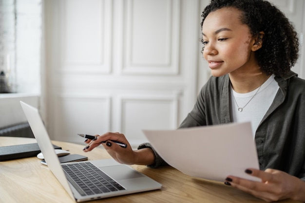 A female financier uses a laptop to work in an office coworking
space company finance report