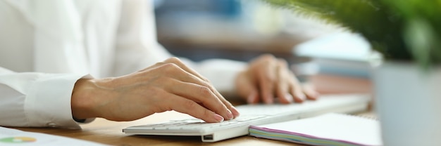 Female financier working on keyboard close up