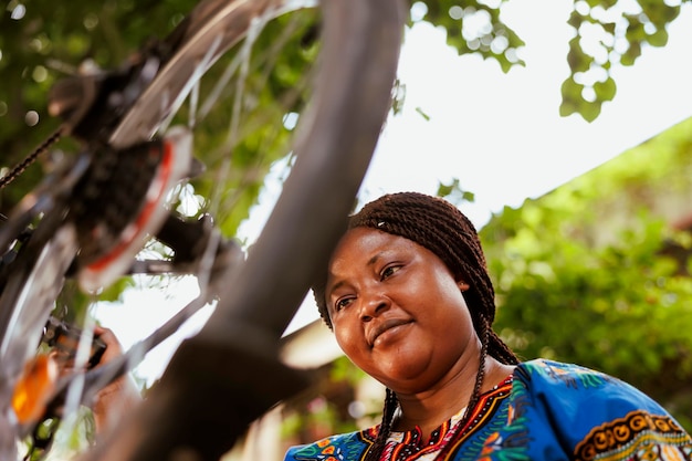 Female fixing bicycle tire outside