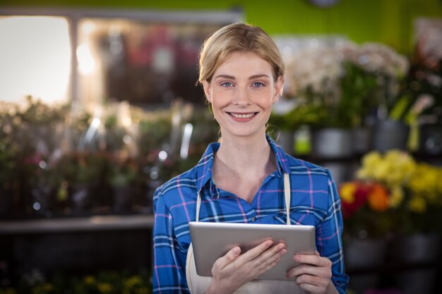 Female florist holding digital tablet