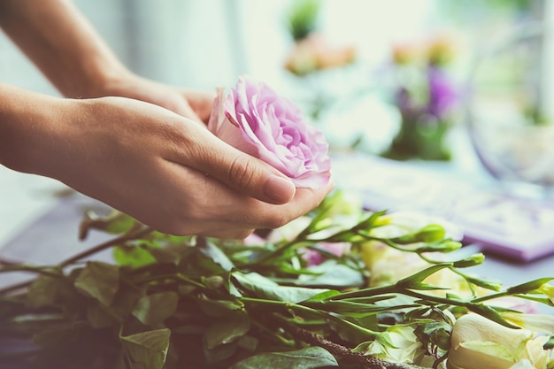 Female florist making beautiful bouquet at flower shop