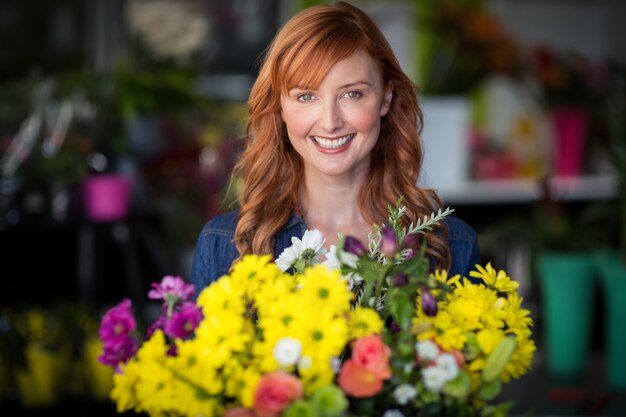 Female florist standing and smiling