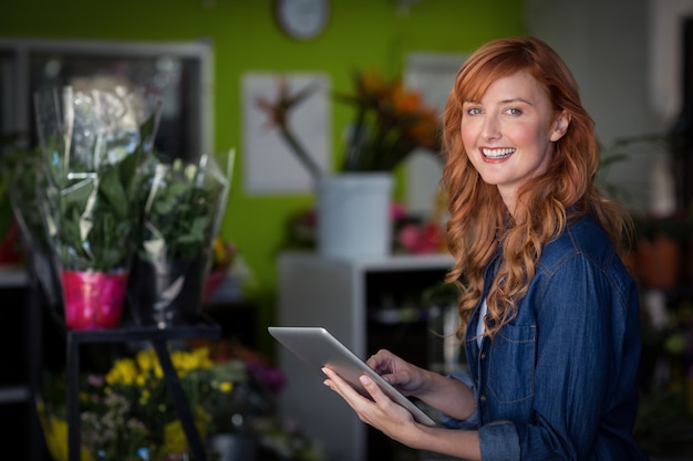 Female florist using digital tablet