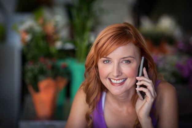 Female florist using mobile phone