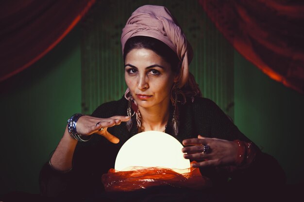 Photo female fortune teller with crystal ball